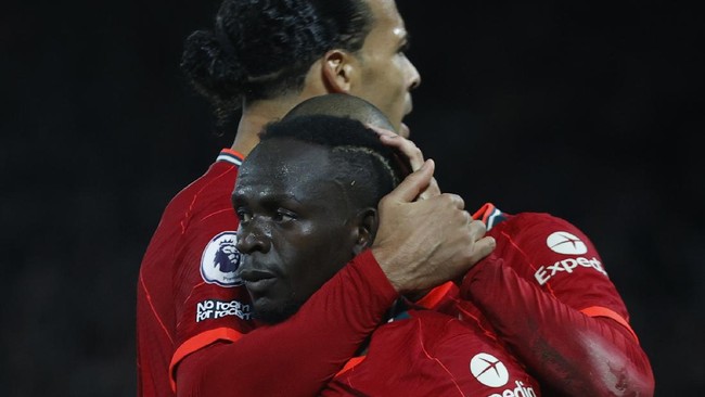 Saat tiga penjaga gawang Liverpool kompak berfoto memegang piala Carabao Cup, Sadio Mane tak sengaja terlihat menenteng sajadah.