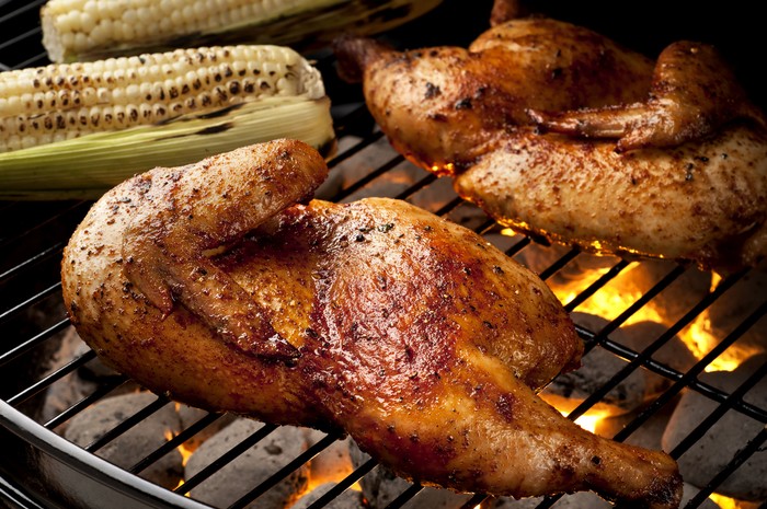 Whole chicken on the grill with corn on the cob. Please see my portfolio for other food related images. Whole chicken on the grill with corn on the cob. Please see my portfolio for other food related images.