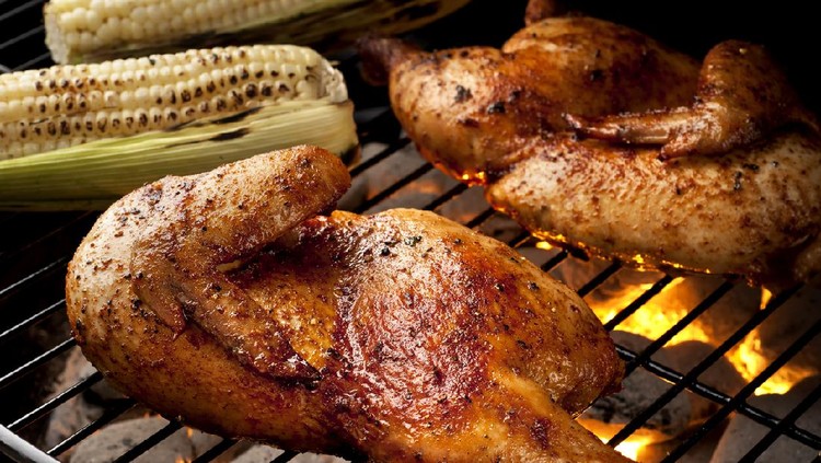 ayam bakar Whole chicken on the grill with corn on the cob. Please see my portfolio for other food related images.
