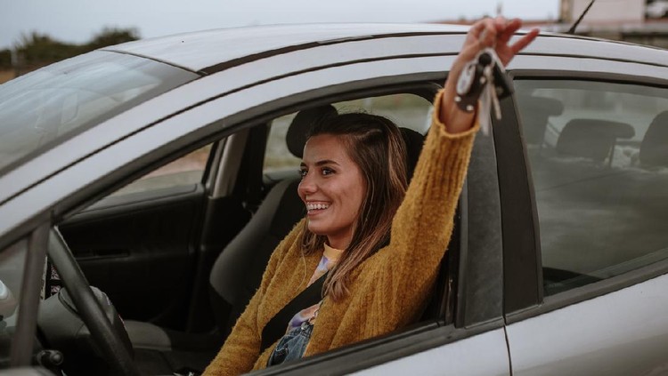 Ilustrasi Tips Menabun untuk Beli Rumah atau Kendaraan A young woman with a happy expression on her face, holding her new car keys