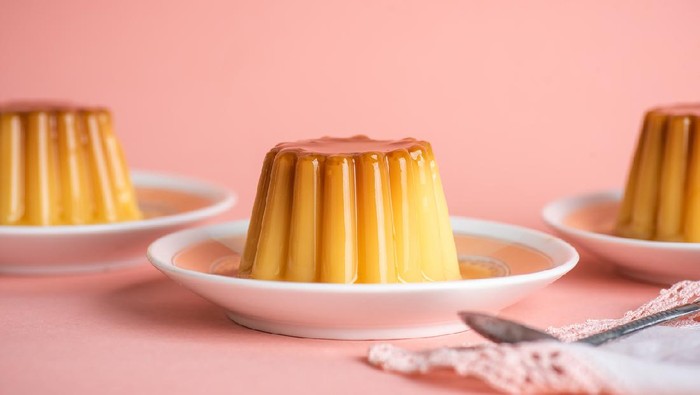 Homemade pudding soft vanilla dessert in cup mold shape on a plate