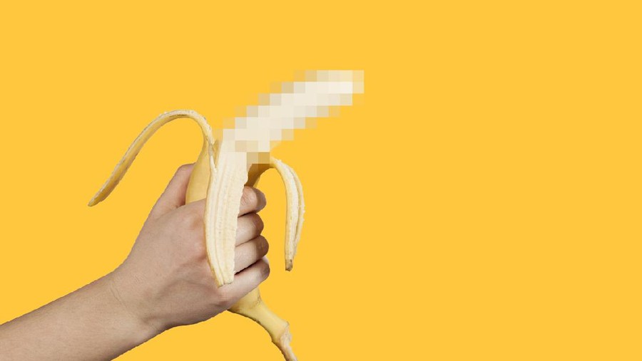 Ilustrasi penis Banana as a symbol of male penis in hand on a yellow background hidden by censorship. Sexual masturbation and orgasm, impotence problem. Self-pleasure concept.