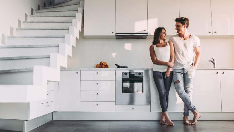 ilustrasi rumah minimalis Full-length image of romantic couple at home. Attractive young woman and handsome man are enjoying spending time together while standing on light modern kitchen.