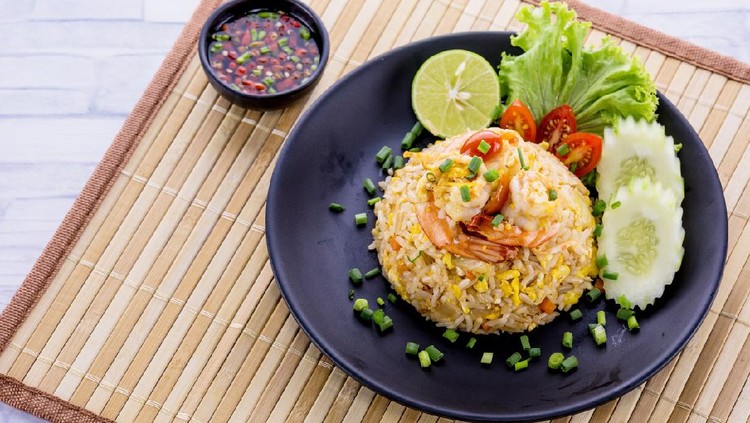 Fried rice with prawn on wooden table