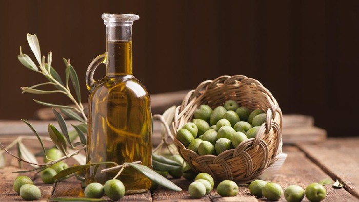 Olive oil and olives on wooden rustic table