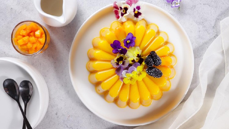 Puding mangga or Homemade fresh mango jelly topping with edible flower.