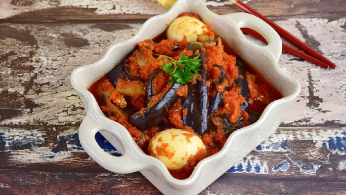 Indonesian Food, Terong Telur Balado, eggplant and egg with spicy chili sauce garnish with parsley.