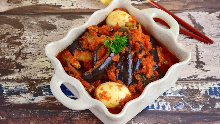 Indonesian Food, Terong Telur Balado, eggplant and egg with spicy chili sauce garnish with parsley.