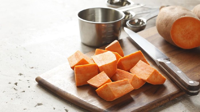 preparation of sweet potatoes on cutting board.