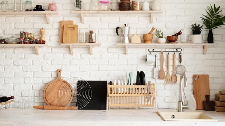 Rustic kitchen interior with brick wall and white wooden shelves, front view