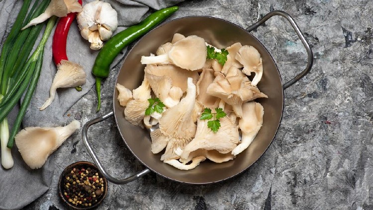 Pleurotus ostreatus or the oyster mushrooms and iratake in japanese with cooking ingredients on a table ready for food preparation tabletop view