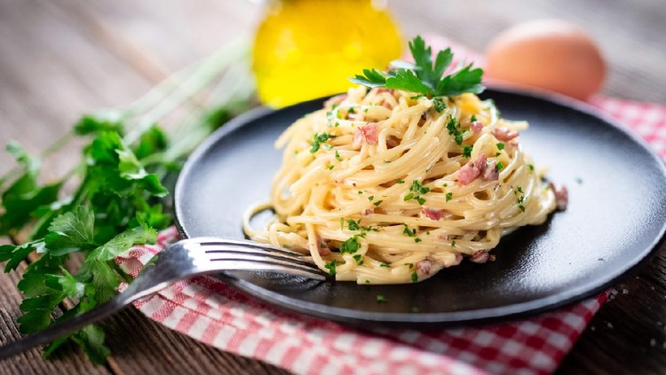 Spaghetti alla carbonara. Pasta with pancetta, egg, parmesan cheese and cream sauce.