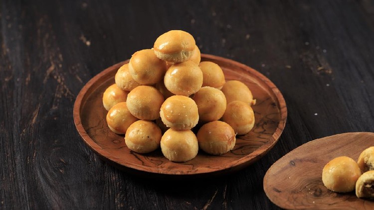 A Pile of Nastar or Ananas Taartjes or Pineapple Tart, Most Popular Various of Kue Kering Lebaran, Usually Served During Hari Raya. Wooden Background with Negative Space.