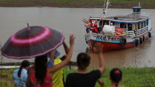 FOTO: Sinterklas Arungi Sungai Amazon Antar Kado Natal