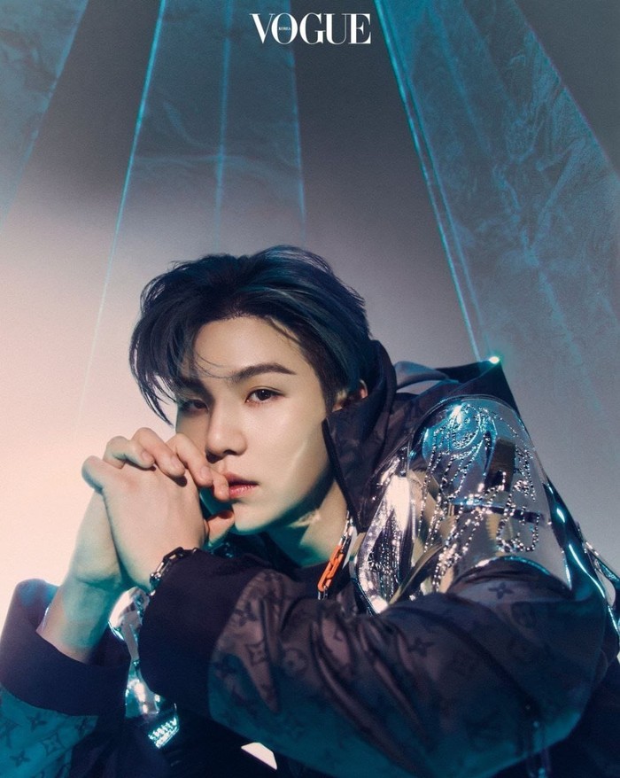 Suga tampil stylish dengan pilihan jaket hitam dengan aksen hologram dari koleksi Louis Vuiton tentunya. Cocok dengan kepribadiannya yang dikenal cool. (@voguekorea)