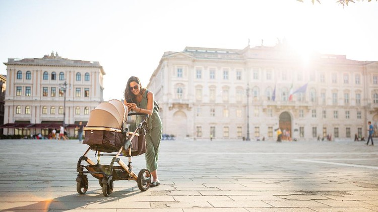 Young Italian woman walking with her baby&period; Trieste&comma; Itly