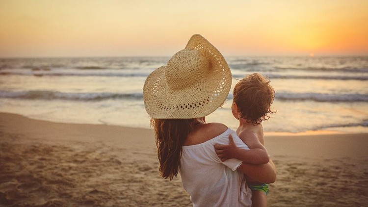 Family on holidays in sunset on the beach