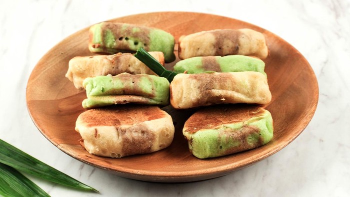 Pukis Pandan Chocolate is a Popular Traditional Snack in Indonesia or Jajan Pasar. This Snack is One Varian of Jajanan Pasar. Copy Space on White Background