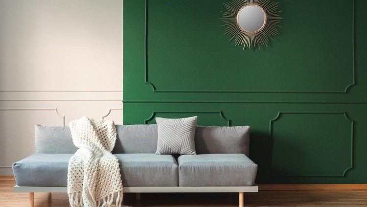White blanket and grey pillow on long comfortable couch in bright living room