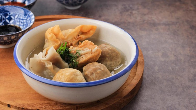 Bakso Arema, Meatballs Food Special from Malang East Java Indonesia. Close Up, on Wooden Board and Rustic Table. Served with SOy Sauce, Sauce, and Chilli Paste