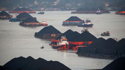 Coal barges are pictured as they queue to be pulled along Mahakam river in Samarinda, East Kalimantan province. (REUTERS/Willy Kurniawan/File Photo)