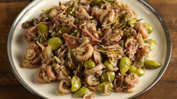 Spicy stir fried salted squid with pete known as tumis cumi asin pedas dengan pete or sambal cumi asin pete in Indonesia.