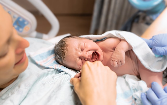 New mom holds her newborn baby in the hospital.