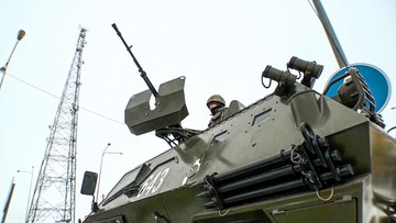 In this image taken from footage provided by the RU-RTR Russian television, a Kazakhstan's soldier stands atop of a military vehicle at a check point in Kazakhstan, Friday, Jan. 7, 2022. The President of Kazakhstan said Friday he authorized law enforcement to open fire on 