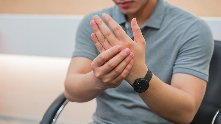 close up employee man massage on his hand and arm for relief pain from hard working ,carpal tunnel syndrome concept