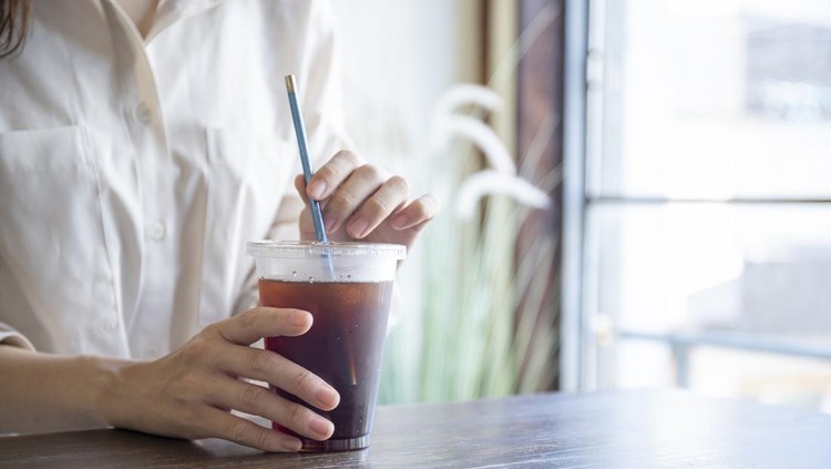 Women drinking coffee with their straws