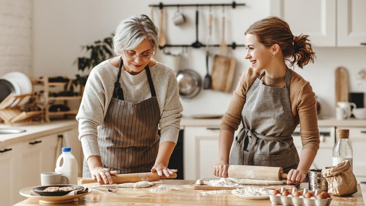 mertua happy family grandmother old mother mother-in-law and daughter-in-law daughter cook in kitchen, knead dough and bake cookies