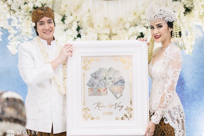 Tak ketinggalan, musisi Kevin Aprilio dan Vicy Melanie yang menikah pada 25 Oktober 2020 lalu pun mengusung adat Sunda saat akad berlangsung. Mereka tampak senada dengan busana putih dan siger dikenakan terlihat memesona. / Foto: Instagram/ @kevinaprilio