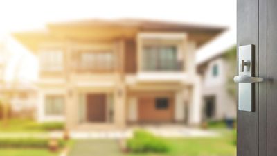 opened wooden door to modern home exterior as background