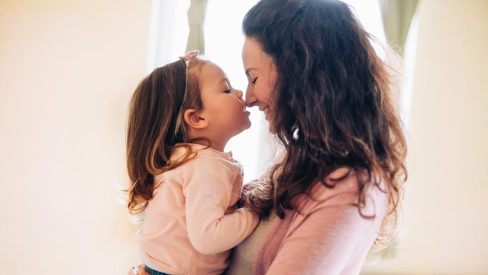 Mother hug her daughter in home