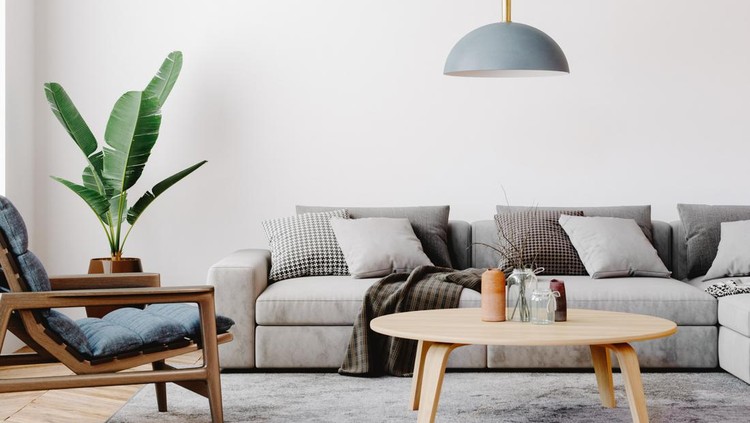 ilustrasi ruang tamu Modern living room setup with classic parquet floor. Furnished with light gray sofa, blue arm chair with wooden frame, modern blue ceiling lamp, wooden coffee table and gray carpet.