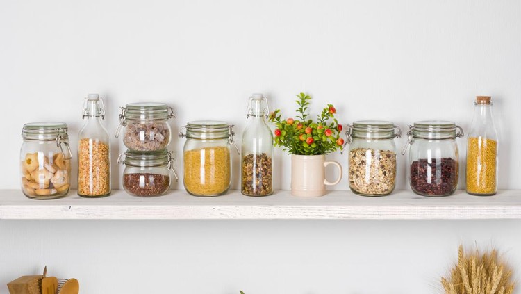 Modern kitchen shelves with various food ingredients on white background