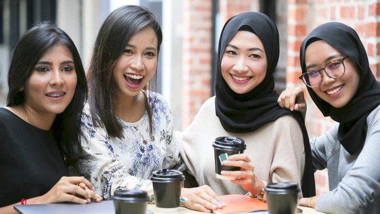 Young and modern group of Malaysian girls, posing for a photo shoot at a coffee shop