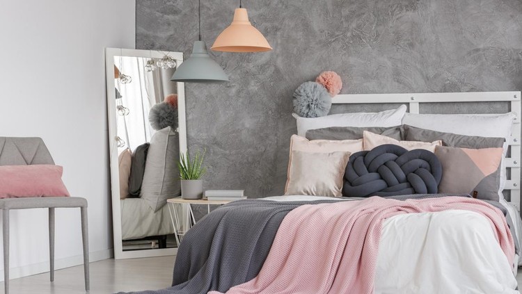 Two small lampshades hanging in modern pastel girly bedroom