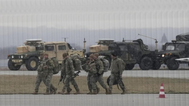 U.S. Army troops of the 82nd Airborne Division unloading vehicles from a transport plane after arriving from Fort Bragg at the Rzeszow-Jasionka airport in southeastern Poland, on Sunday, Feb. 6, 2022. Additional U.S. troops are arriving in Poland after President Joe Biden ordered the deployment of 1,700 soldiers here amid fears of a Russian invasion of Ukraine. Some 4,000 U.S. troops have been stationed in Poland since 2017. (AP Photo/Czarek Sokolowski)