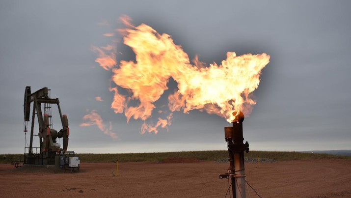 FILE - In this Aug. 26, 2021 file photo, a flare burns natural gas at an oil well Aug. 26, 2021, in Watford City, N.D. The world's facing an energy crunch. Europe is feeling it worst as natural gas prices skyrocket to five times normal, forcing some factories to hold back production. Reserves depleted last winter haven't been made up, and chief supplier Russia has held back on supplying extra. Meanwhile, the new Nord Stream 2 gas pipeline won't start operating in time to help if the weather is cold, and there's talk Europe could wind up rationing electricity. China is feeling it too, seeing power outages in some towns. (AP Photo/Matthew Brown, file)