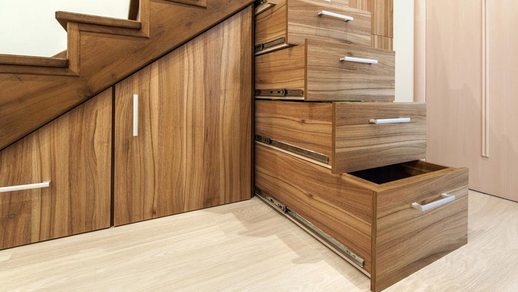 Modern architecture interior with  luxury hallway with glossy wooden stairs in modern storey house. Custom built pullout cabinets on glides in slots under stairs