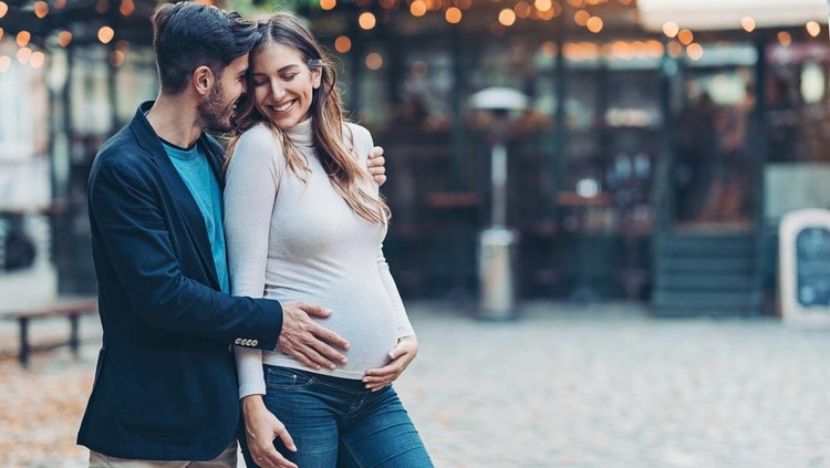 Happy young family expecting a baby