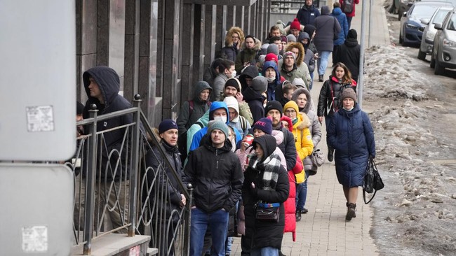 Warga Rusia harus antre berjam-jam demi menarik uang tunai di mesin ATM usai negara barat menjatuhkan sanksi ke Rusia atas serangan terhadap Ukraina.