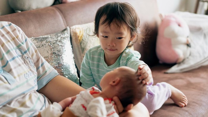 New Asian sister welcoming her brother with affection and love