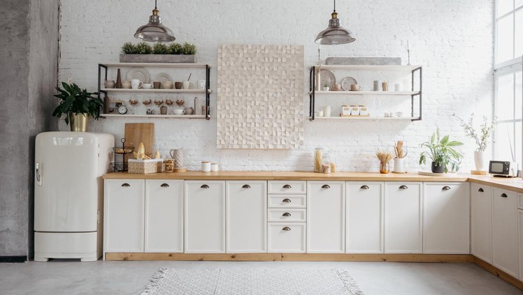 Rustic kitchen interior with white brick wall. Modern room design with wooden furniture, cozy home with vintage decoration. Tabletop with food, shelves with ceramic kitchenware.