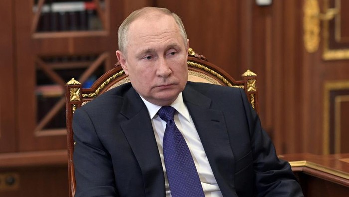 Russian President Vladimir Putin listens to St. Petersburg's governor Alexander Beglov during their meeting in the Kremlin in Moscow, Russia, Tuesday, March 1, 2022. (Alexei Nikolsky, Sputnik, Kremlin Pool Photo via AP)