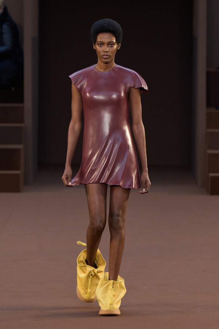 Gaun baby doll aksen lipit ini menampilkan efek serupa busana yang tertiup angin. Foto: Filippo Fior/GoRunway/Vogue