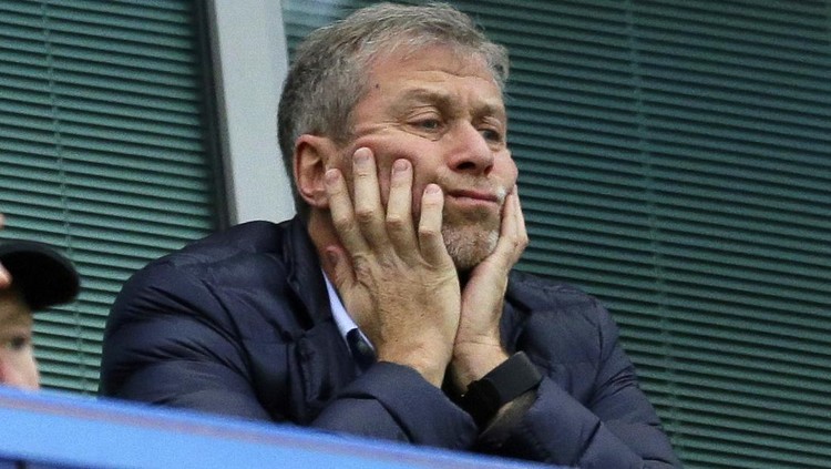 FILE - Chelsea soccer club owner Roman Abramovich sits in his box before their English Premier League soccer match against Sunderland at Stamford Bridge stadium in London, Dec. 19, 2015. Chelsea owner Roman Abramovich has on Saturday, Feb. 26, 2022 suddenly handed over the “stewardship and care” of the Premier League club to its charitable foundation trustees. The move came after a member of the British parliament called for the Russian billionaire to hand over the club in the wake of Russia’s invasion of Ukraine. (AP Photo/Matt Dunham, File)