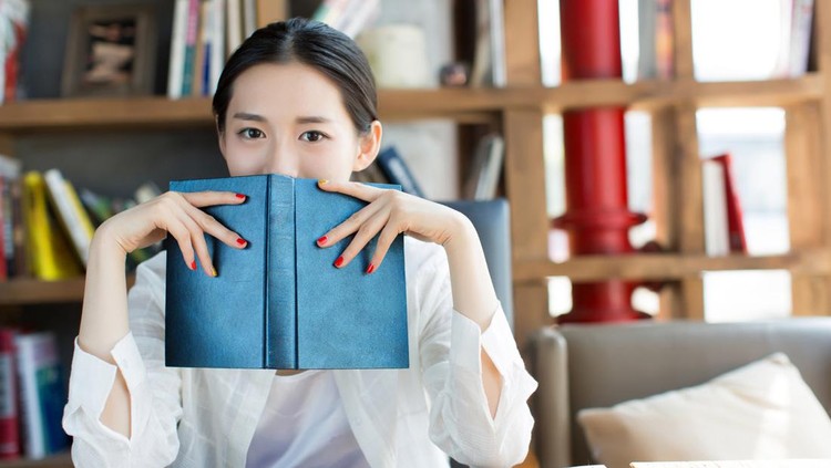 chinese female students in the library, reading a person alone