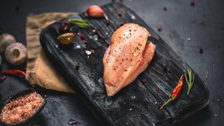 Fresh organic chicken breast with spices ready to cook